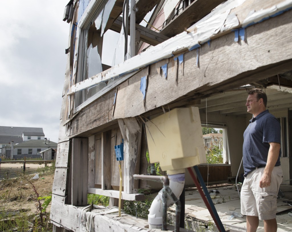 Gary Silberman surveys the damage from his parents' home in Lindenhurst, N.Y., in 2014 after Hurricane Sandy. Technically, Sandy wasn't even a hurricane when it made landfall in New Jersey.