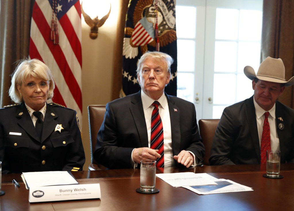 President Trump, with Carolyn "Bunny" Welsh, sheriff of Chester County, Pa., left, and A.J. Louderback, sheriff of Jackson County, Texas, attends a roundtable discussion on border security with local leaders Friday.