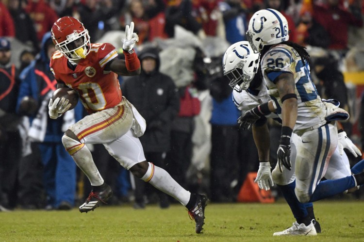 Kansas City wide receiver Tyreek Hill gestures as he runs past Indianapolis safety Clayton Geathers and linebacker Anthony Walker during the second half of the Chiefs' 31-13 win in the AFC divisional round on Saturday in Kansas City, Missouri.