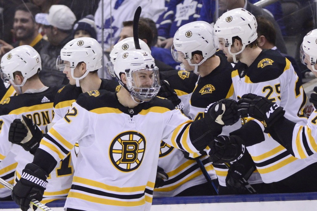 Bruins center Sean Kuraly is congratulated by his teammates afer scoring a goal the tying goal Saturday night in Boston's 3-2 win over the Toronto Maple Leafs. Kuraly finished with a goal and two assists.
