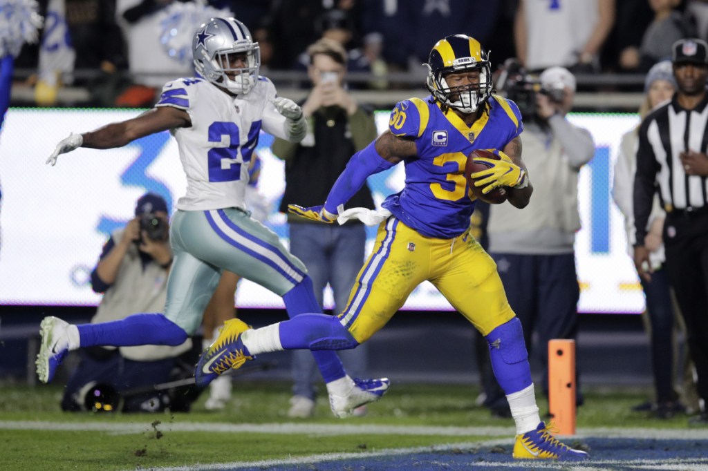 Rams running back Todd Gurley outraces Cowboys cornerback Chidobe Awuzie for a touchdown Saturday night in an NFC divisional-round game. The Rams won, 30-22.