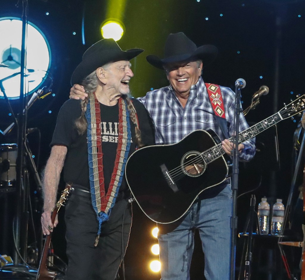 Willie Nelson, left, and George Strait perform at "Willie: Life & Songs Of An American Outlaw" at Bridgestone Arena on Saturday in Nashville, Tenn.