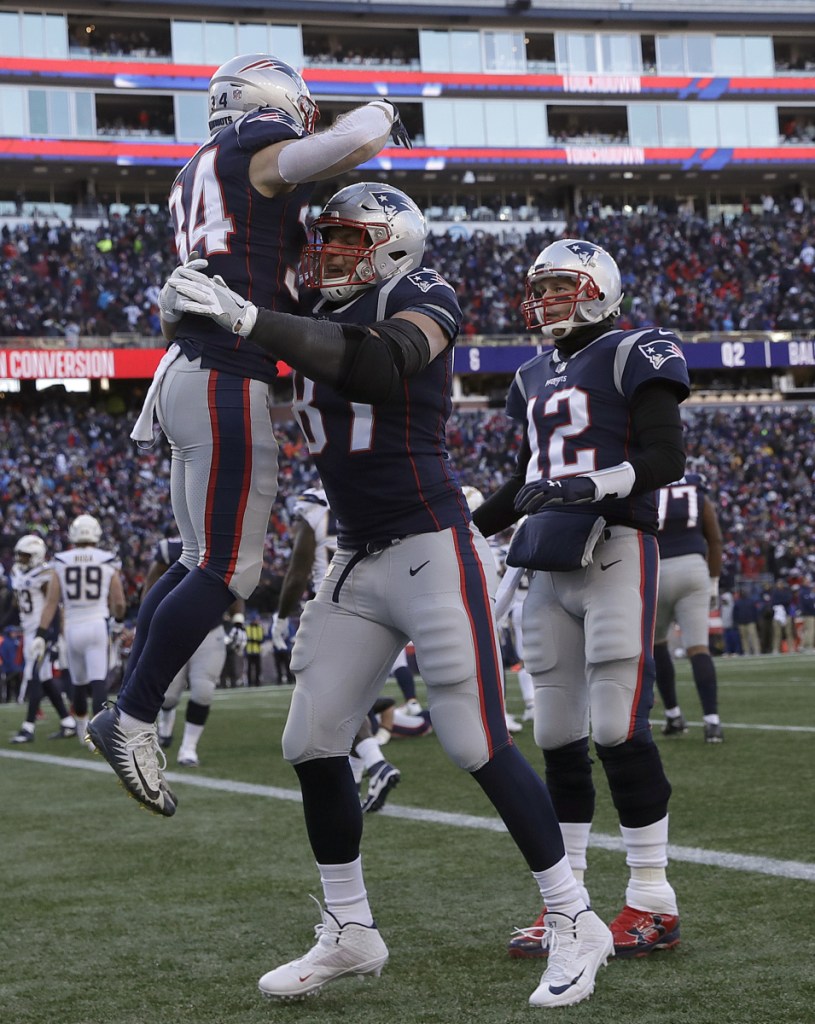 Rex Burkhead receives a lift from Rob Gronkowski after scoring in the first half of the Patriots' 41-28 victory Sunday against the Los Angeles Chargers.