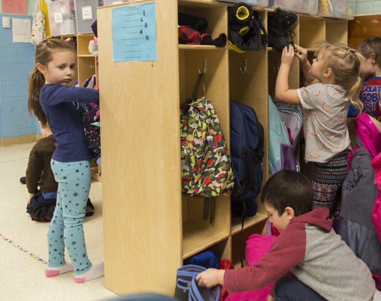 Pre-kindergarten students store their snow clothes in their cubbies after returning to class at John F. Kennedy Memorial School in Biddeford, which has one of the few districts in Maine that offer pre-K to all 4-year-olds who want to attend.