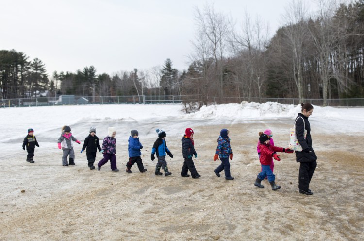 Pre-kindergarten teacher Melissa Wu walks her students back to class last week at John F. Kennedy Memorial School in Biddeford, which has one of the few districts in Maine that offer pre-K to all 4-year-olds who want to attend.