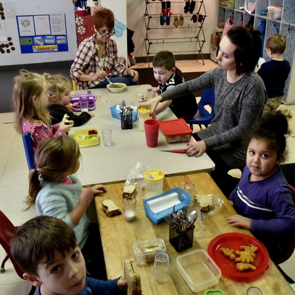 Teachers and children sit together for lunch in the pre-school room at the Children's Place at the Maine Children's Home for Little Wanderers in Waterville.