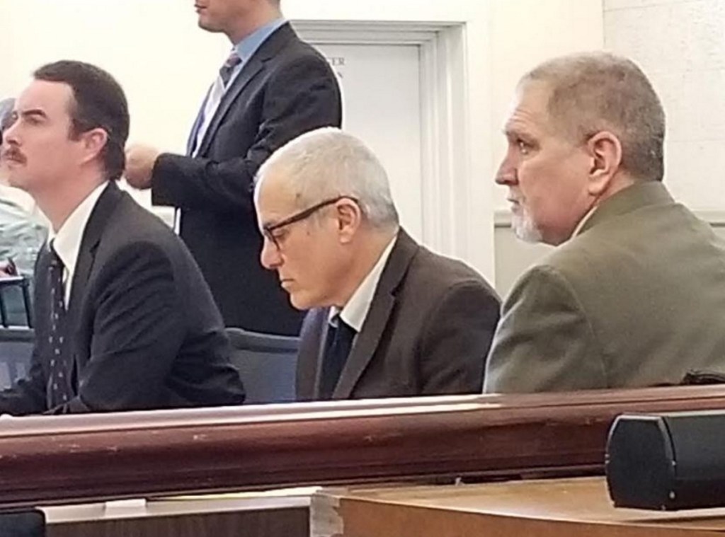 James "Ted" Sweeney, 58, right, formerly of Jay, listens to closing arguments Monday during his murder trial in Franklin County Superior Court in Farmington. His attorneys, seated from left, are Thomas J. Carey and Walter Hanstein.