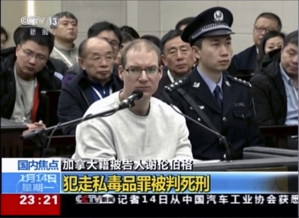 In this image taken from a video footage run by China's CCTV, Canadian Robert Lloyd Schellenberg attends his retrial at the Dalian Intermediate People's Court in Dalian, northeastern China's Liaoning province on Monday. A Chinese court sentenced the Canadian man to death Monday in a sudden retrial in a drug smuggling case that is likely to escalate tensions between the countries over the arrest of a top Chinese technology executive. (CCTV via AP)