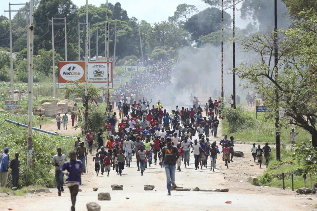 Protesters gather on the streets Monday during demonstrations over the increase in fuel prices in Harare, Zimbabwe.