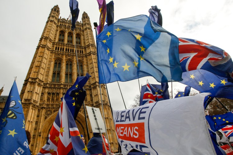 Anti and pro-Brexit demonstrators wave European Union flags, Union Jacks and banners during protests outside the Houses of Parliament in London on Tuesday, when British lawmakers were voting on a plan to exit the European Union.