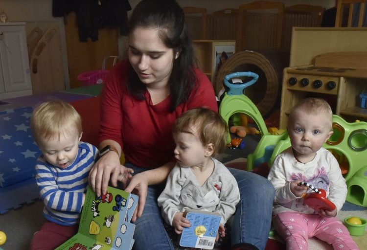 Children's Place assistant teacher Cassidy Brown reads aloud at the Maine Children's Home for Little Wanderers. The private nonprofit may soon have to cut the number of children it serves.