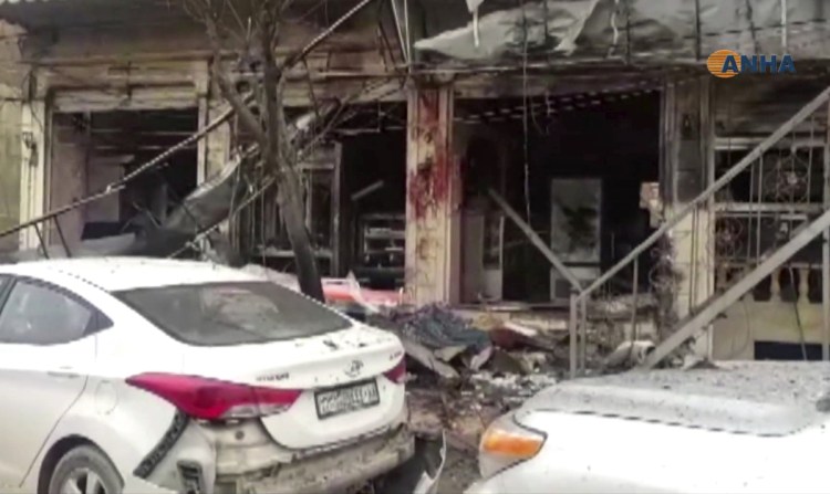 This image from video provided by Hawar News, ANHA, the news agency for the semi-autonomous Kurdish areas in Syria, shows a damaged restaurant where an explosion occurred in Manbij, Syria, on Wednesday.