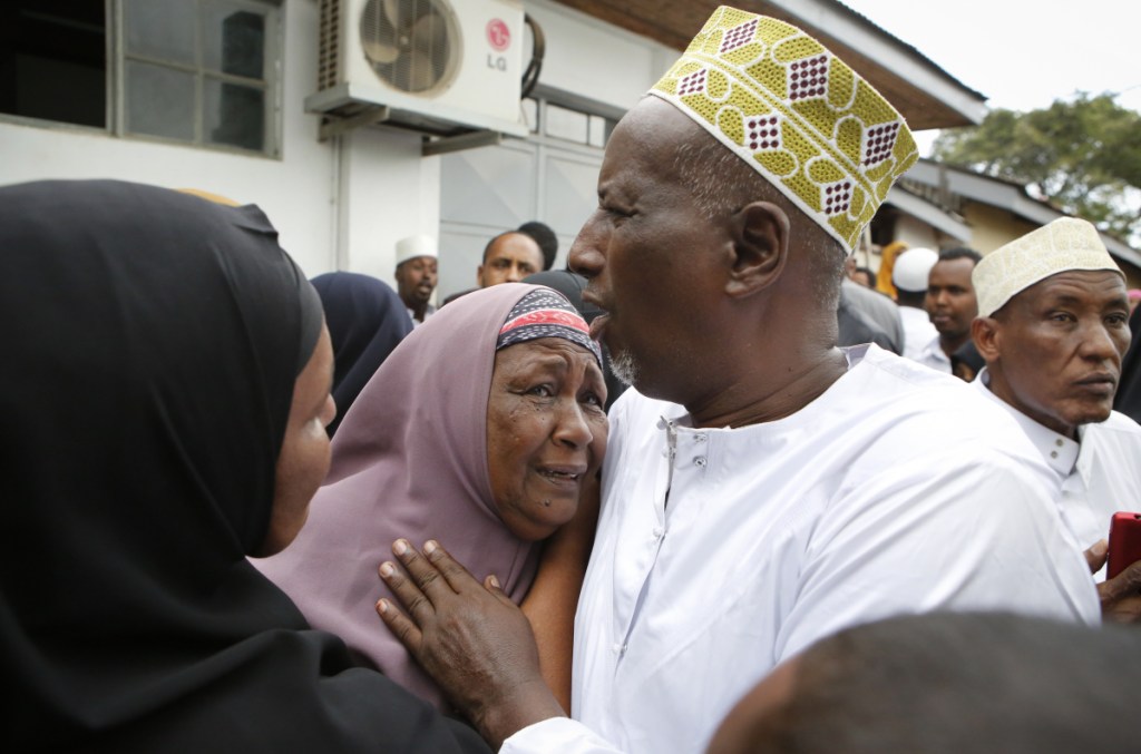 Mourners grieve as they prepare to pray over the bodies of Abdalla Dahir and Feisal Ahmed, who were killed in Tuesday's attack, at a mosque in Nairobi, Kenya, on Wednesday. The two worked for the Somalia Stability Fund, managed by the London-based company Adam Smith International, and were killed in Tuesday's assault by Islamic extremist gunmen on a luxury hotel and shopping complex.