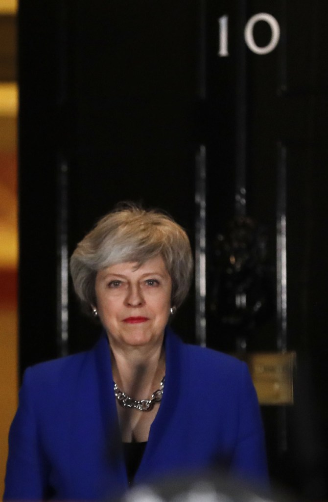 British Prime Minister Theresa May arrives Wednesday to speak outside 10 Downing St.
