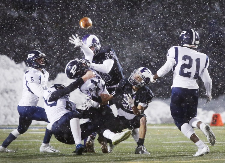 The prospect of a combined football team, featuring players from both Deering and Portland High, would end a 100-plus-year tradition, the annual Thanksgiving Day game, like this one played in snowy conditions last fall.