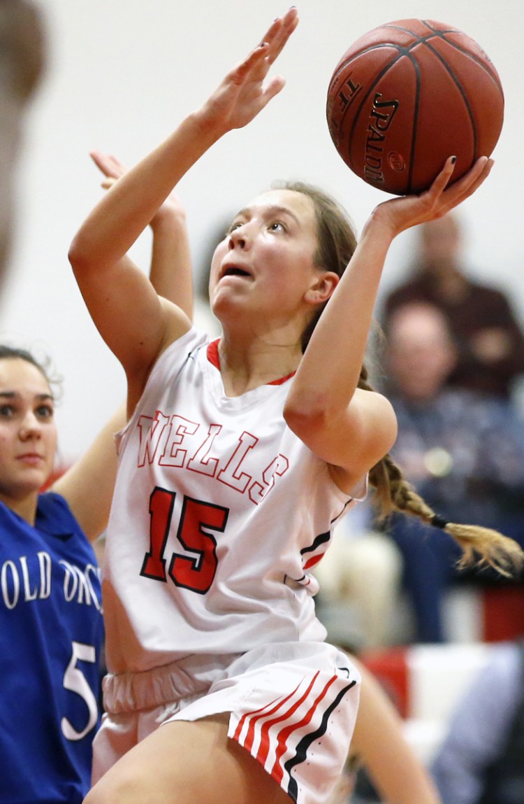 Franny Ramsdell, who scored 28 points Thursday night for Wells, takes a shot while defended by Ganelle Ferguson of Old Orchard Beach. Wells won, 55-45.