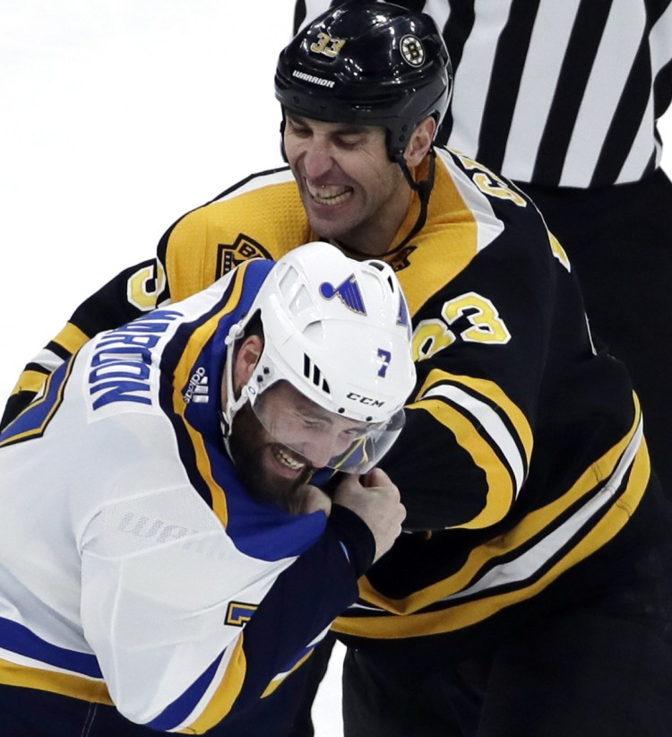 Boston's Zdeno Chara gets involved in a first-period fight with Pat Maroon of the Blues Thursday night at Boston.