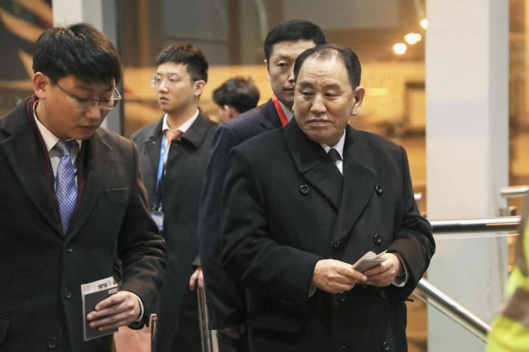 North Korean official Kim Yong Chol, right, prepares to leave the Beijing International Airport on Thursday.