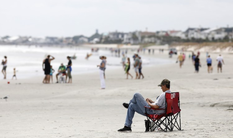 Beach goers hang out at the Isle of Palms, S.C., as Hurricane Florence spins out in the Atlantic ocean in September 2018. South Carolina Gov. Henry McMaster and Attorney General Alan Wilson, both Republicans, have been working on their state's response to the Trump administration's announcement of a five-year plan to open 90 percent of the nation's offshore reserves to private development.