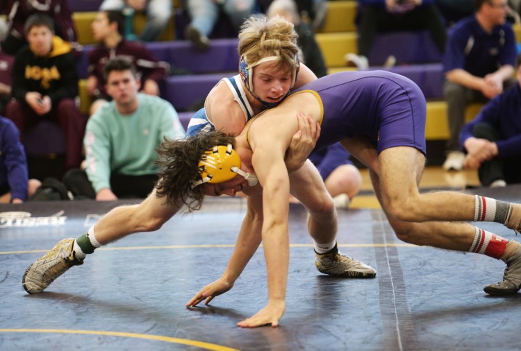 Kennebunk's David York, top, battles with Joe Macaluso of Cheverus during the Cheverus Invitational. York won the 132-pound division, and York High won the team title by a half point over Mountain Valley, while Kennebunk finished third.
