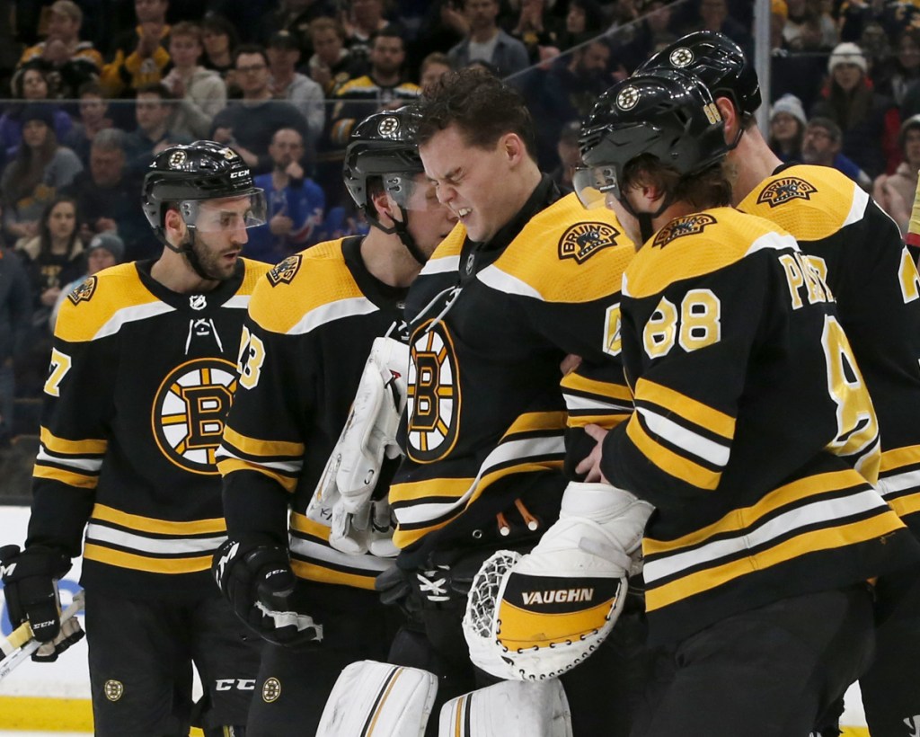 Bruins goalie Tuukka Rask is helped off the ice after Filip Chytil of the Rangers crashed into him while scoring a goal Saturday night. Rask did not return to the game, and the Rangers won, 3-2.