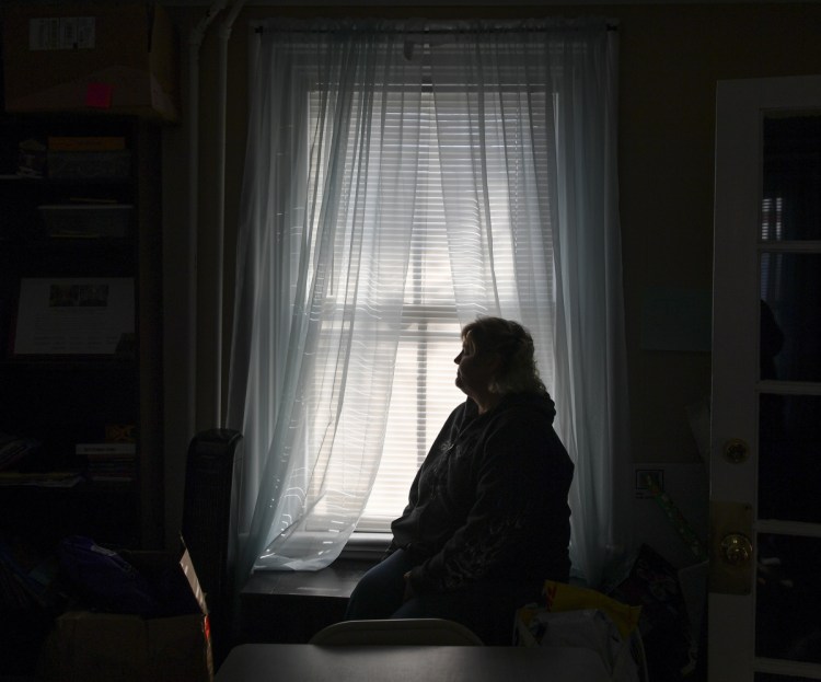 A woman who sought help at the Eastern Panhandle Empowerment Center women's shelter after enduring domestic abuse waits in the facility in Martinsburg, W.Va.