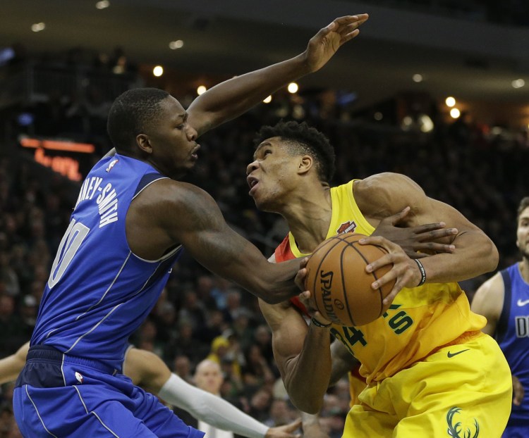 Milwaukee's Giannis Antetokounmpo, right, is fouled by Dallas' Dorian Finney-Smith during the second half of the Bucks' 116-106 win Monday in Milwaukee.