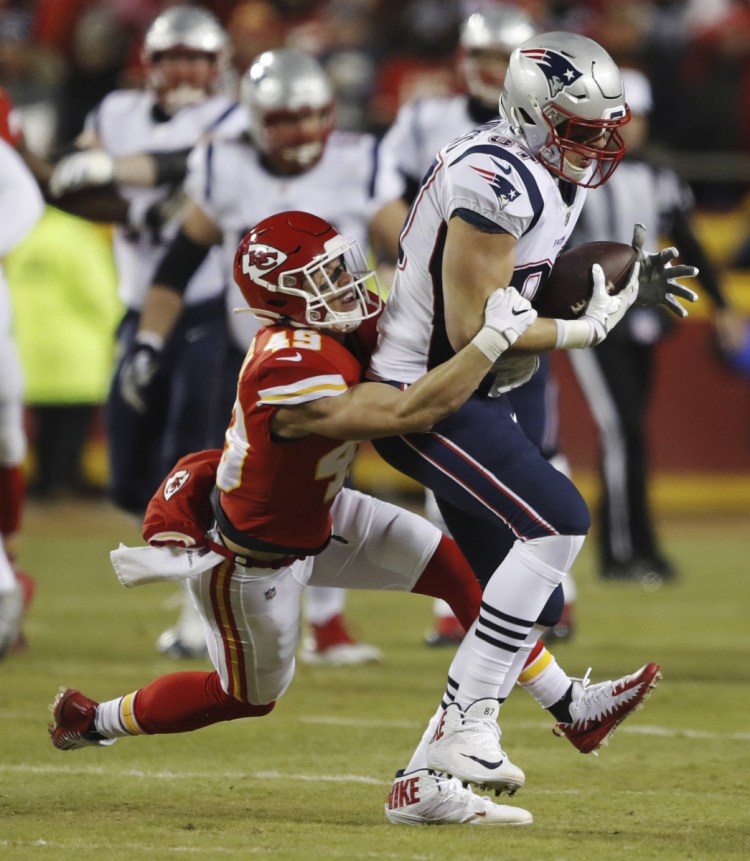 New England Patriots tight end Rob Gronkowski (87) makes a catch against Kansas City Chiefs defensive back Daniel Sorensen (49) during the first half of the AFC Championship NFL football game, Sunday, Jan. 20, 2019, in Kansas City, Mo. (AP Photo/Charlie Neibergall)