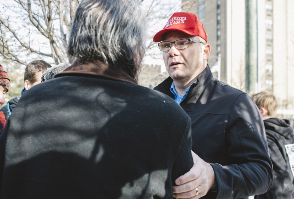 Trump supporter Don Wegman, right, approaches Guy Jones, a Native American at a protest outside the Covington Catholic Diocese in Covington, Kentucky, on Tuesday. The two exchanged phone numbers in the hope of meeting to discuss mending relations.