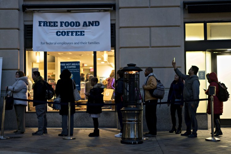 Customers wait in line outside a restaurant opened by chef Jose Andres for federal workers and their families during a partial government shutdown in Washington, D.C. 