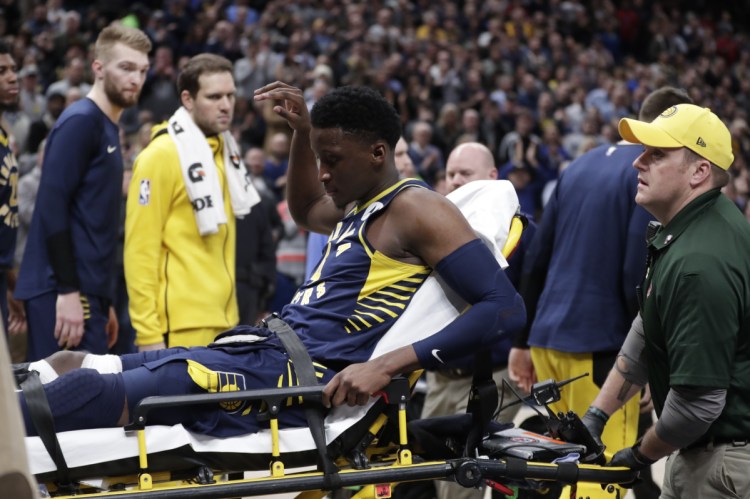 Pacers guard Victor Oladipo is taken off the court on a stretcher after went down with a right knee injury Wednesday night against Toronto.