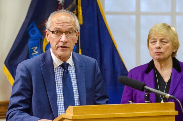 Gordon Smith, left, is named by Gov. Janet Mills as the state's first-ever director of opioid response at a news conference on Thursday at the State House. He said, "The opioid epidemic continues to take a horrific toll on our state."