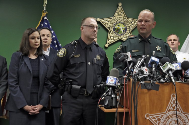 Highlands County Sheriff Paul Blackman, right, speaks to the media as he stands with Florida Attorney General Ashley Moody, left, and Sebring Police Chief Karl Hoglund, center, during a news conference on Thursday in Sebring, Fla. Five people were shot and killed Wednesday at a SunTrust Bank.