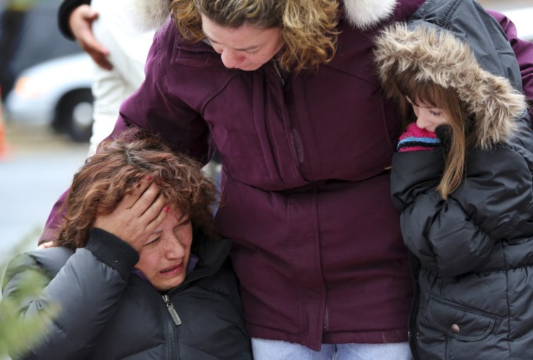 Mourners grieve in 2012 after the shootings at Sandy Hook Elementary School in Newtown, Conn., which killed 26 people. Three more mass shootings during the 2017-18 school year killed 29 people – in Florida, Texas and New Mexico.