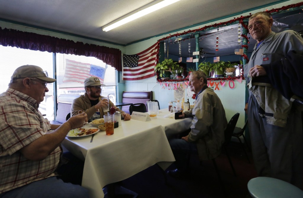 Gene Henderson, from left, Brandon Henderson and Terry Rose, right, have lunch at Angie's Cafe in Fort Hancock, Texas. Gene Henderson, a 69-year-old Vietnam veteran and retired Border Patrol agent who now has a small farm, said the government shutdown could cement President Trump's 2020 re-election.