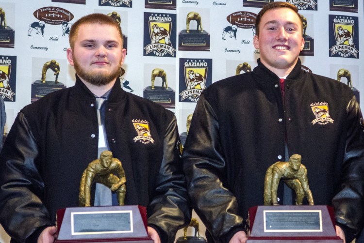 Offensive lineman Aidan McGlone of Bonny Eagle, left, and defensive lineman Thomas Palmer of Thornton Academy hold Frank Gaziano Awards on Saturday at the Augusta Civic Center.