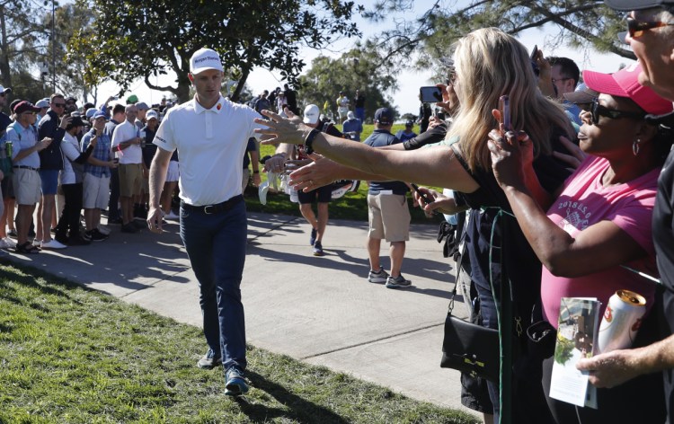 Justin Rose greets the crowd on his way to the seventh hole Saturday during the third round of the Farmers Insurance Open in San Diego.