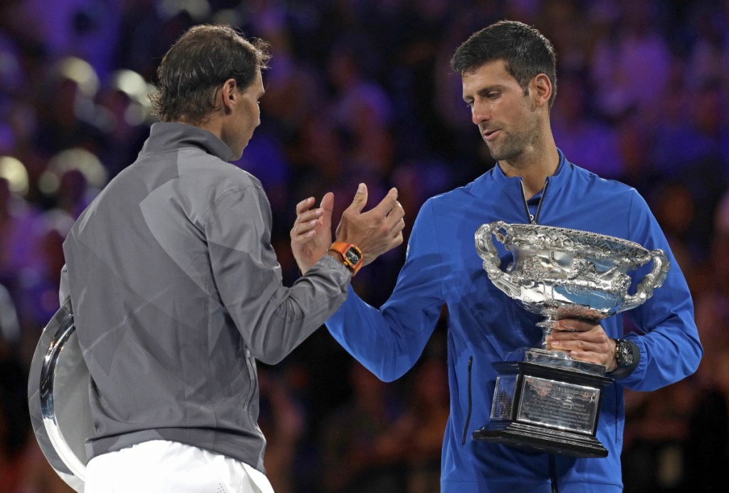 Novak Djokovic, right, shakes hands with Rafael Nadal on the podium Sunday after sweeping to a 6-3, 6-2, 6-3 victory in the Austalian Open final. Now the question is whether anyone is good enough to threaten the two men's tennis leaders.