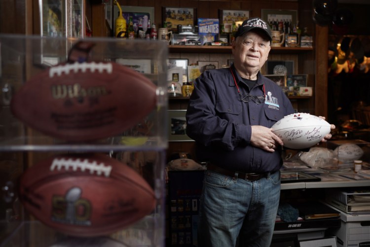 Don Crisman poses for a photo in his Kennebunk home Monday, holding a Super Bowl LI ball signed by a few Patriots players. He thought health issues would put an end to his streak of attending every Super Bowl. "But here we are," the 82-year-old said. "I just hope (the Patriots) bring home trophy No. 6."