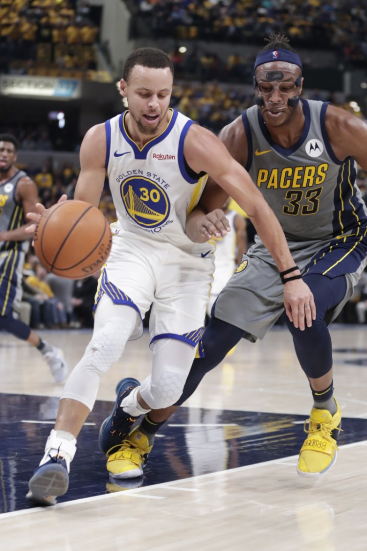 Golden State guard Stephen Curry drives past Indiana center Myles Turner during the first half of the Warriors' 132-110 win Monday in Indianapolis.
