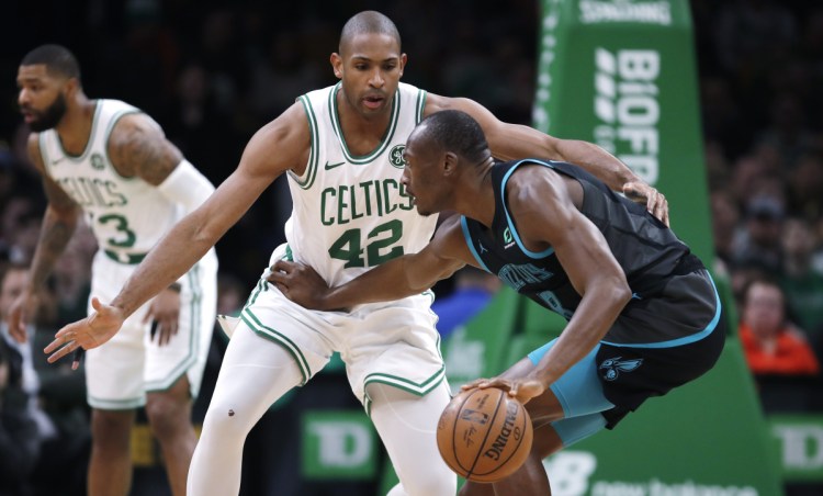 Celtics center Al Horford tries to trap Charlotte's Bismack Biyombo during the first quarter Wednesday night at Boston.