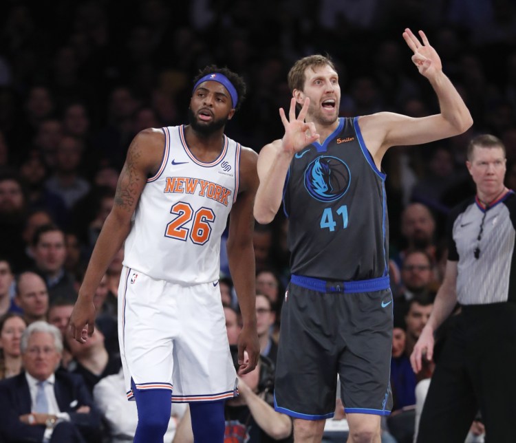 Mavericks forward Dirk Nowitzki signals to his bench with Knicks center Mitchell Robinson awaiting an official's call during the first half Wednesday night at New York.