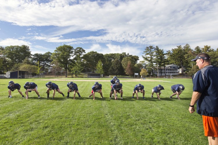 Traip Academy's junior varsity football team runs through a drill in Kittery in 2017. Advocates of eight-man football hope it helps some Maine high schools that struggle with participation to keep their programs afloat.