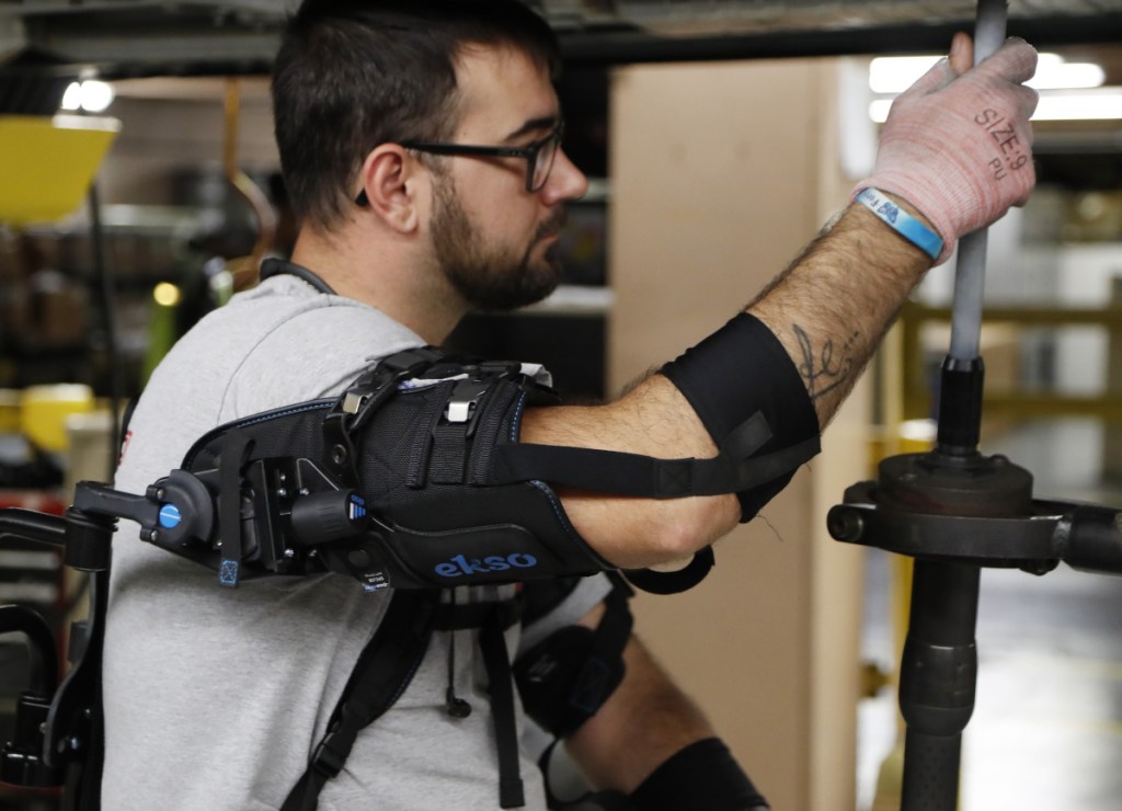 Ford assembly line worker Nicholas Gotts wears a new wearable technology called an EksoVest.