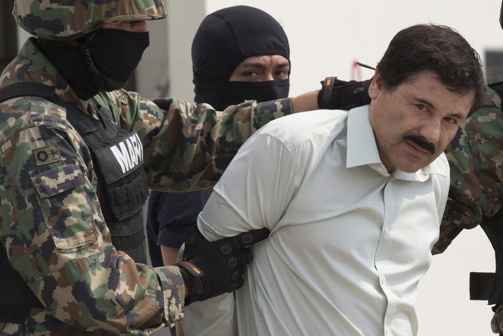 Joaquin "El Chapo" Guzman is escorted to a helicopter by Mexican security forces at Mexico's International Airport in Mexico city, Mexico, on Feb. 22, 2014. MUST CREDIT: Bloomberg photo by Susana Gonzalez