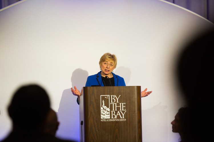 Gov. Janet Mills speaks at the Portland's Martin Luther King celebration Monday night. She called on the audience to work to raise up all people, especially people “from away.”