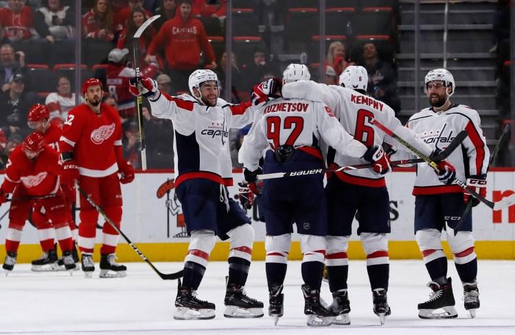 Washington celebrate after scoring a goal during a 3-2 win over the Detroit Red Wings on Sunday in Detroit.