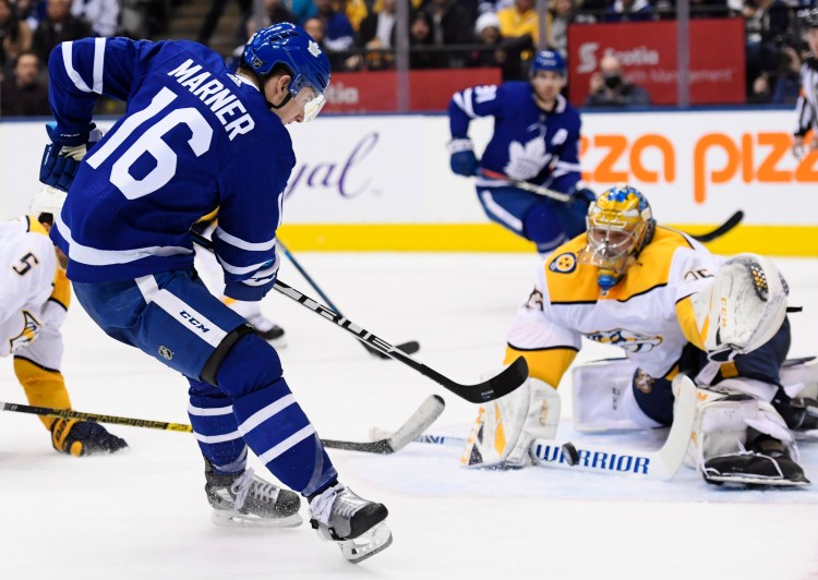 Toronto Maple Leafs right wing Mitchell Marner (16) shoots against Nashville Predators goaltender Pekka Rinne (35) during second-period Monday in Toronto.