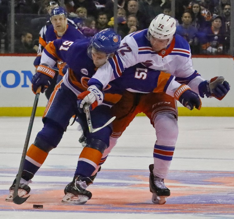 New York Islanders' Valtteri Filppula, left, shields the puck from New York Rangers' Filip Chytil during the Rangers' 2-1 win Saturday at Barclays Center in New York. 