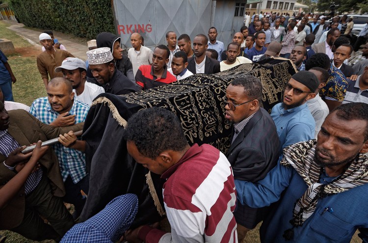 Mourners carry the body of Feisal Ahmed, who was killed with his colleague Abdalla Dahir in Tuesday's attack, as they leave a mosque and head to the funerals in Nairobi, Kenya, on Wednesday. The two were killed by Islamic extremist gunmen who attacked a luxury hotel and shopping complex.